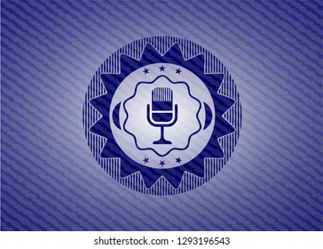 microphone icon inside badge with denim background