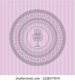 microphone icon inside badge with pink background
