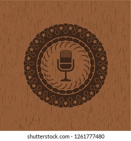 microphone icon inside badge with wood background