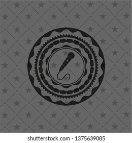microphone icon inside black emblem