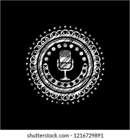 microphone icon inside chalkboard emblem written on a blackboard