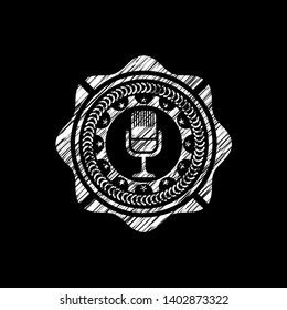 microphone icon inside chalkboard emblem