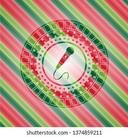 microphone icon inside christmas style emblem.