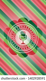 microphone icon inside christmas style emblem.