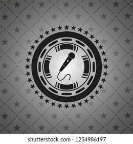 microphone icon inside dark badge or emblem