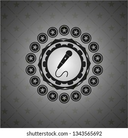 microphone icon inside dark badge or emblem
