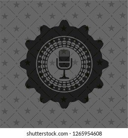microphone icon inside dark emblem
