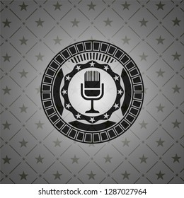 microphone icon inside dark emblem