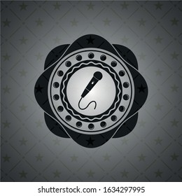 microphone icon inside dark emblem