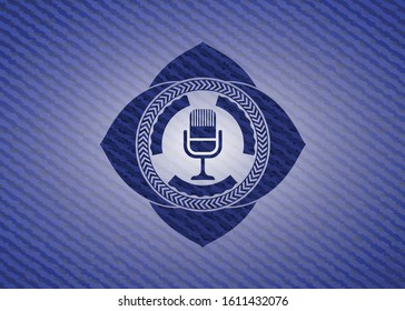 microphone icon inside emblem with denim high quality background