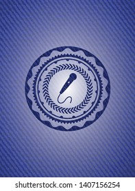 microphone icon inside emblem with jean background