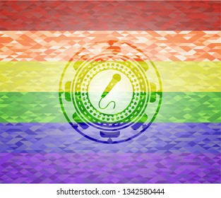microphone icon inside emblem on mosaic background with the colors of the LGBT flag