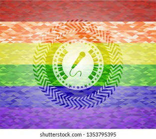 microphone icon inside emblem on mosaic background with the colors of the LGBT flag