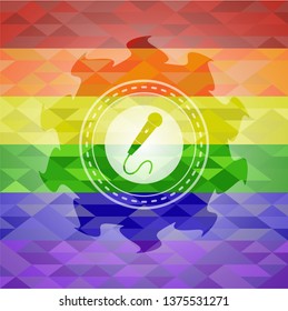 microphone icon inside emblem on mosaic background with the colors of the LGBT flag