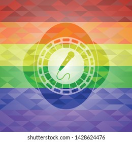 microphone icon inside emblem on mosaic background with the colors of the LGBT flag