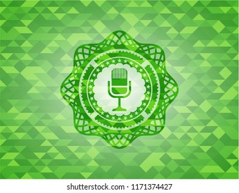 microphone icon inside green emblem with triangle mosaic background