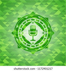 microphone icon inside green emblem with mosaic ecological style background