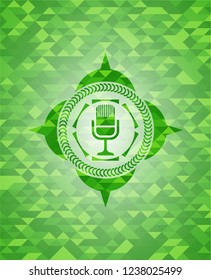 microphone icon inside green emblem with mosaic ecological style background