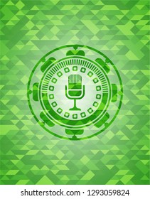 microphone icon inside green emblem with mosaic ecological style background