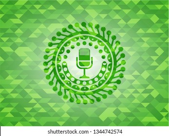 microphone icon inside green emblem. Mosaic background