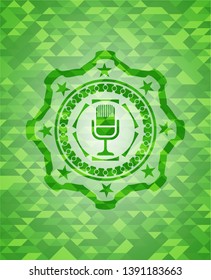 microphone icon inside green emblem with mosaic background