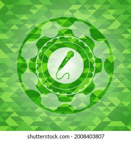 microphone icon inside green emblem with mosaic ecological style background. 