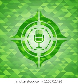 microphone icon inside green mosaic emblem