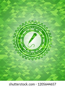 microphone icon inside green mosaic emblem