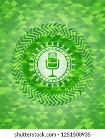 microphone icon inside green mosaic emblem