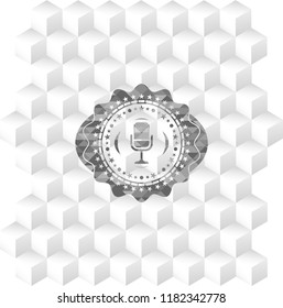 microphone icon inside grey badge with geometric cube white background
