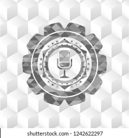 microphone icon inside grey badge with geometric cube white background