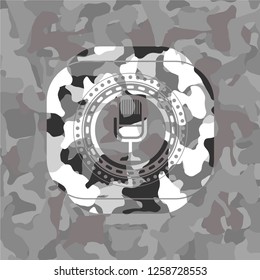 microphone icon inside grey camo emblem