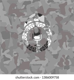 microphone icon inside grey camo emblem