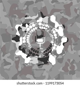 microphone icon inside grey camouflage emblem
