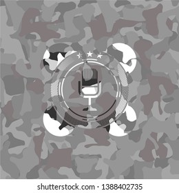 microphone icon inside grey camouflaged emblem