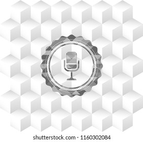 microphone icon inside grey emblem with cube white background