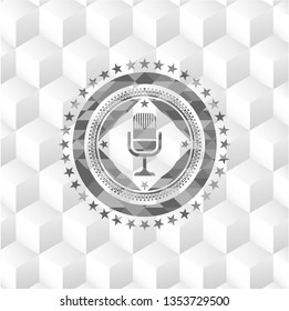 microphone icon inside grey emblem with cube white background