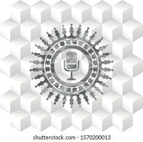 microphone icon inside grey emblem with cube white background