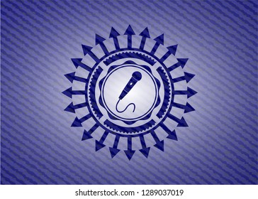 microphone icon inside jean or denim emblem or badge background