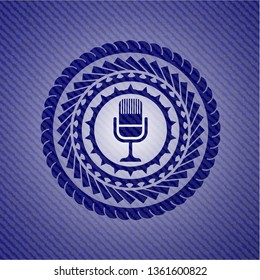 microphone icon inside jean or denim emblem or badge background