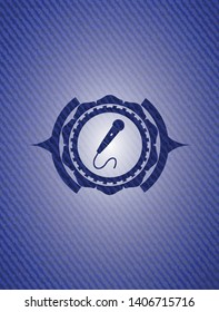 microphone icon inside jean or denim emblem or badge background