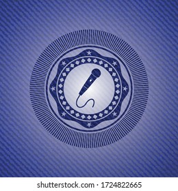 microphone icon inside jean or denim emblem or badge background. 