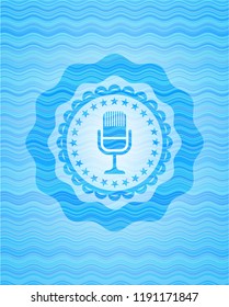 microphone icon inside light blue water wave badge.