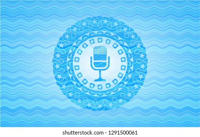 microphone icon inside light blue water wave emblem.