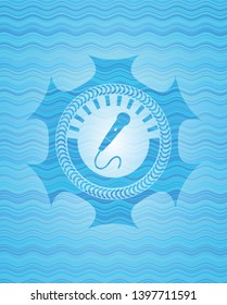 microphone icon inside light blue water wave emblem.
