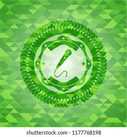 microphone icon inside realistic green mosaic emblem