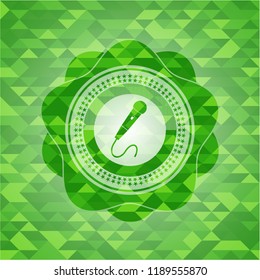 microphone icon inside realistic green mosaic emblem