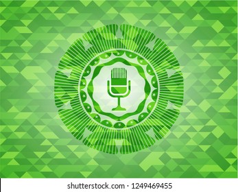 microphone icon inside realistic green mosaic emblem