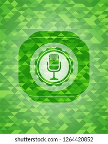 microphone icon inside realistic green mosaic emblem