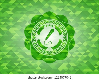microphone icon inside realistic green mosaic emblem